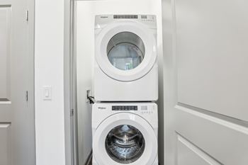 A white washing machine and dryer in a laundry room.